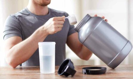 A fit man preparing a whey protein drink