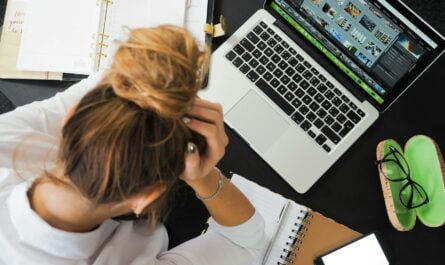 woman sitting in front of macbook