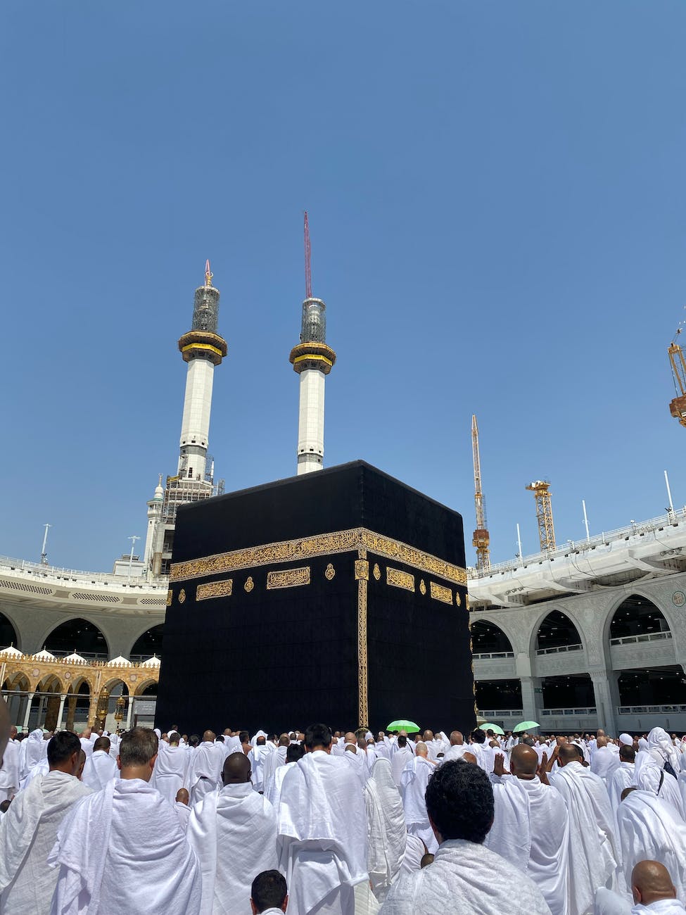pilgrims praying in front of kaaba in the great mosque of mecca