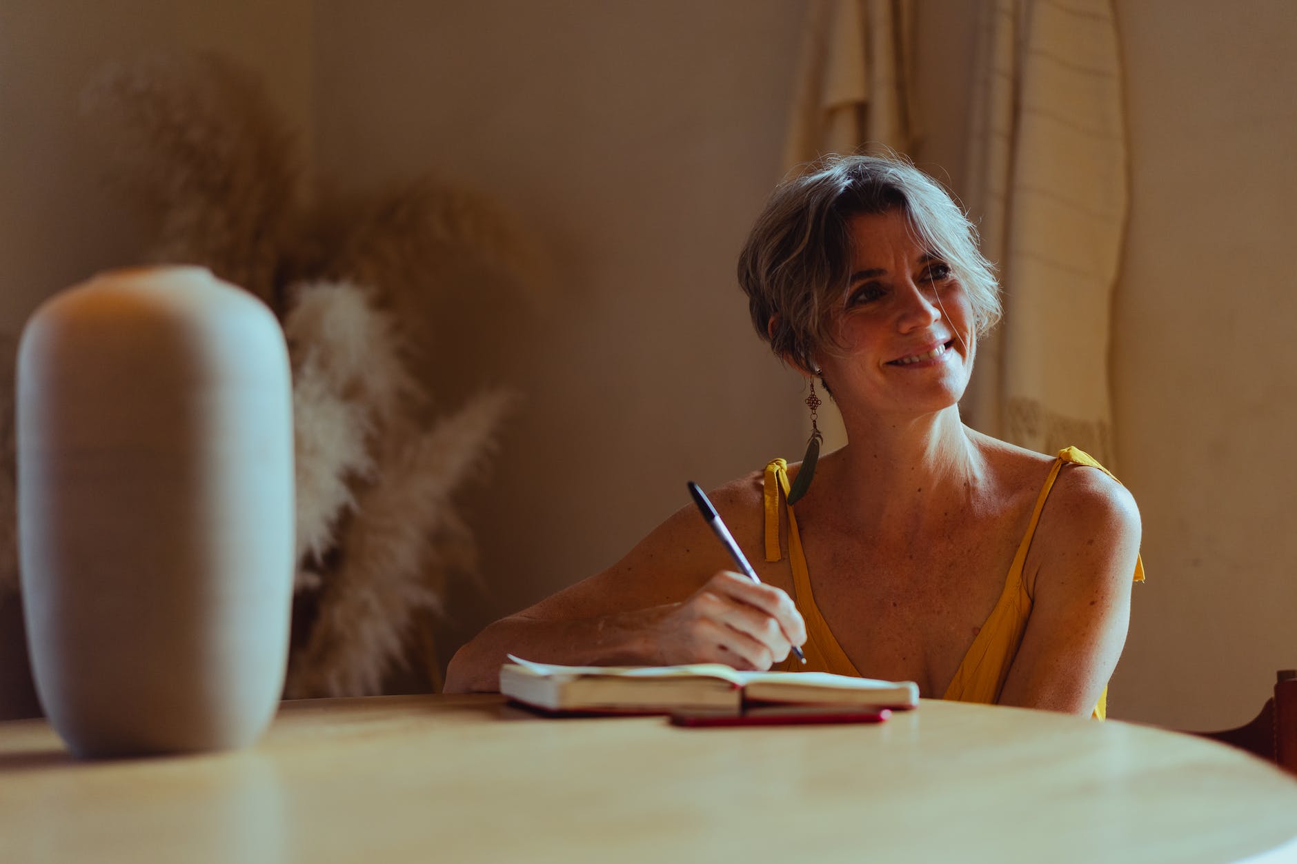 elderly woman writing her diary while smiling