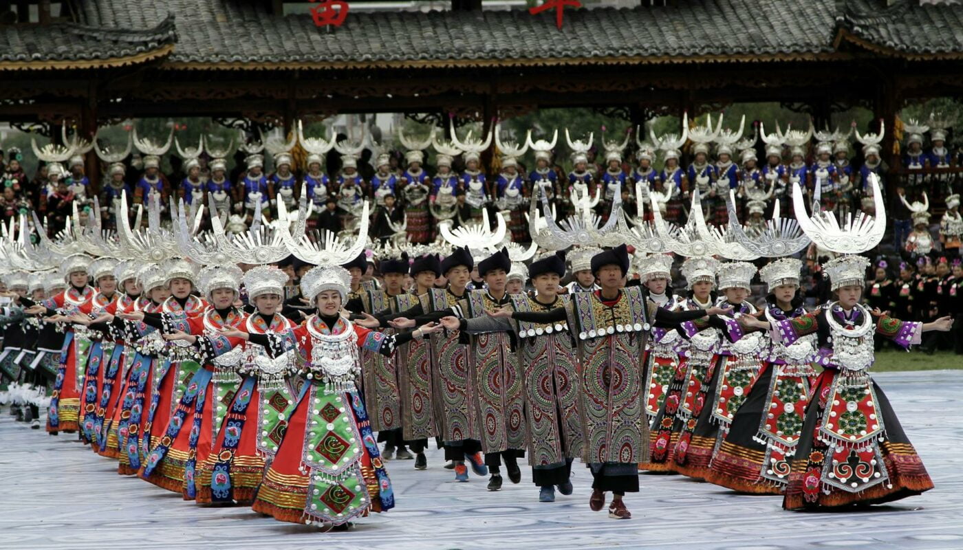 men and women in traditional clothing dancing to celebrate new year