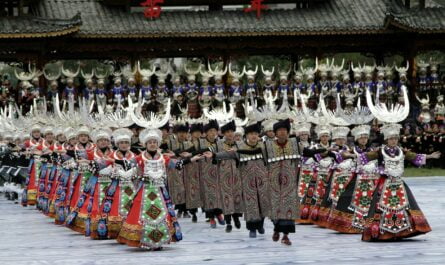 men and women in traditional clothing dancing to celebrate new year