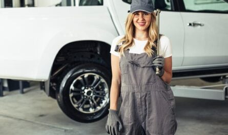 smiley-female-mechanic-holding-wrench_23-2148327566