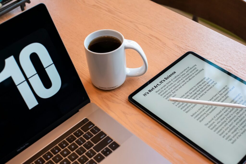 Laptop, coffee, tablet with text - Guide to eBook Writing