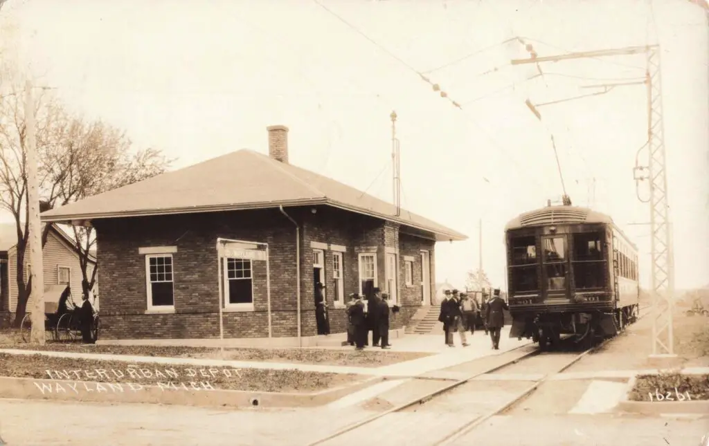 Historic train station with passengers.
