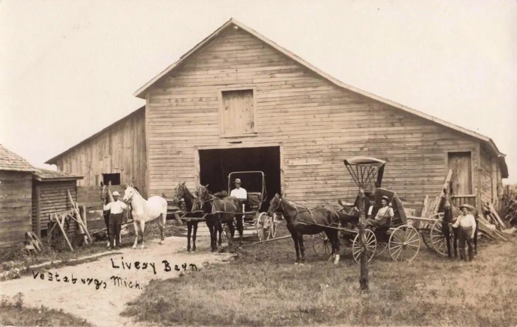 Historic barn with horses and carriages.