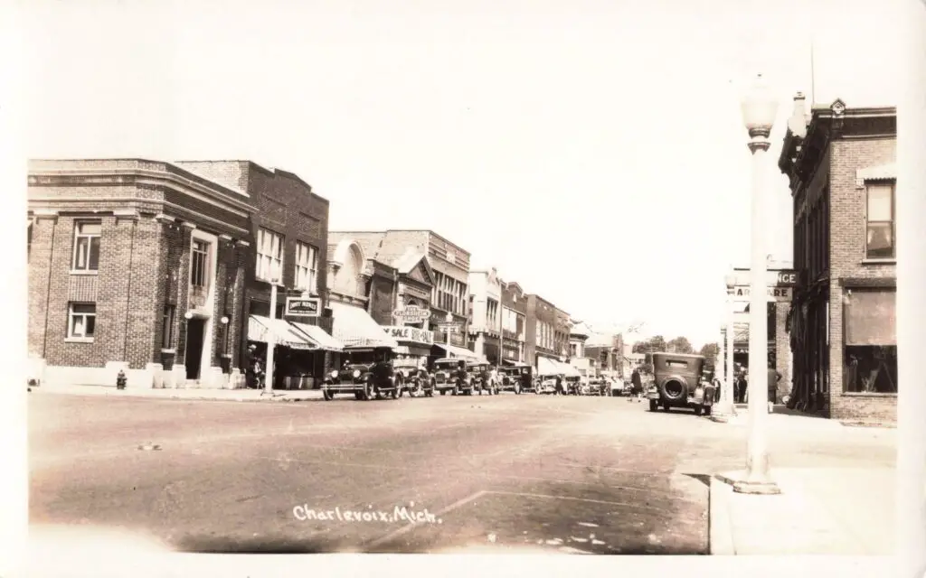 Historic downtown street with vintage cars.